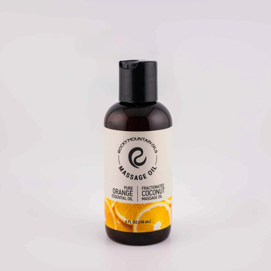 Bottle of Orange Massage Oil, 4oz, from Rocky Mountain Oils, with a clean label design against a natural background.
