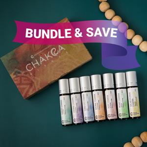 The image displays the Chakra Blends Roll-On Kit, which includes seven small roller bottles with essential oil blends. Each bottle corresponds to a different color and label, representing various chakras.