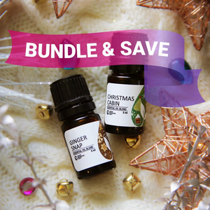 Two essential oil bottles labeled 'Ginger Snap' and 'Christmas Cabin' with decorative elements on a light background.